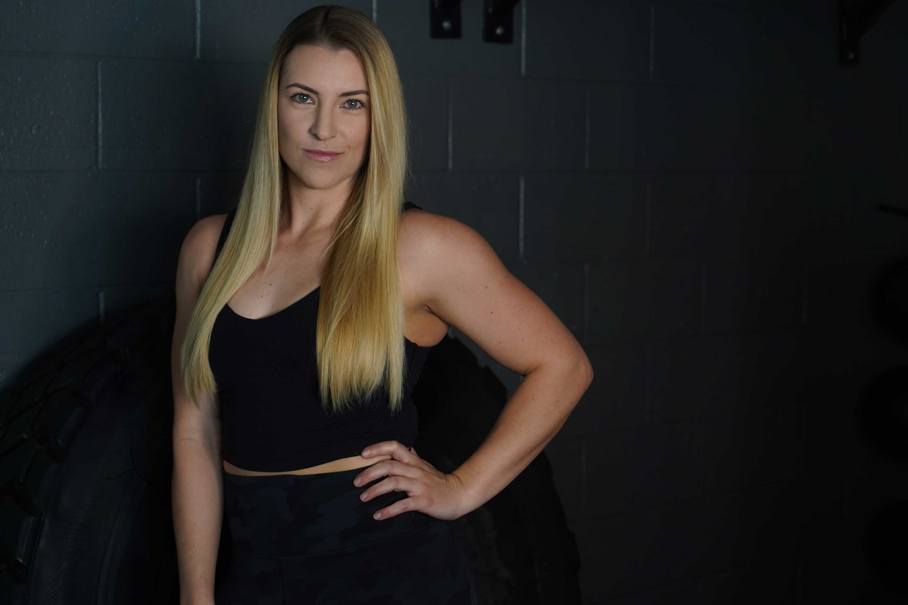 coach with hands on her hips facing the camera